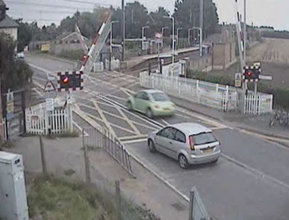 motorist-almost-hit-train-level-crossing-red-light