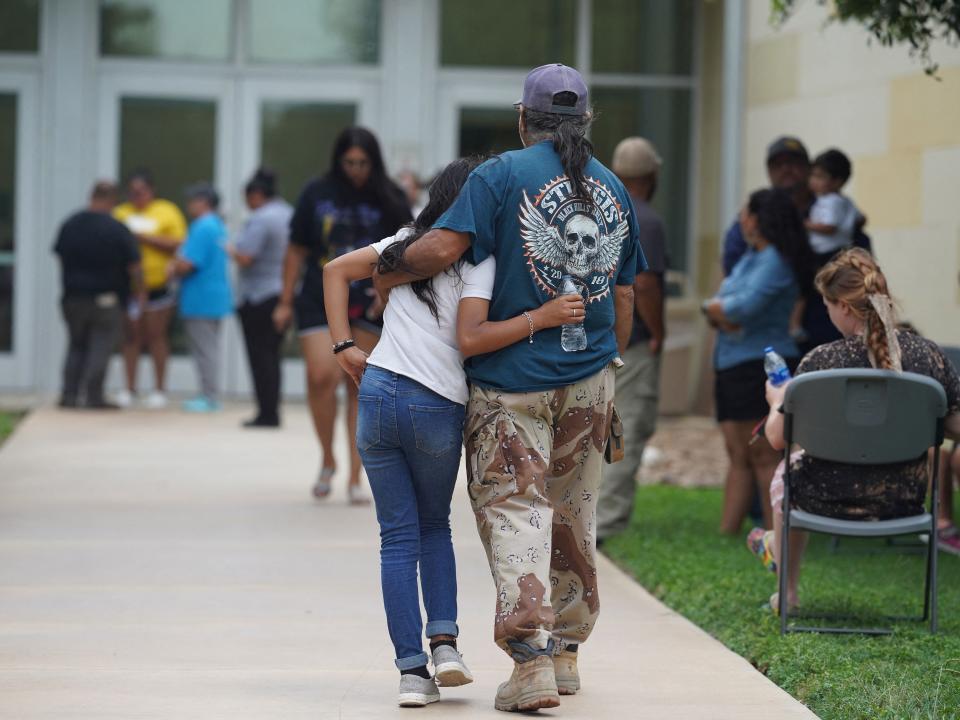 Families gather and hug outside the Willie de Leon Civic Center where grief counseling will be offered in Uvalde, Texas, on May 24, 2022. - A teenage gunman killed 18 young children in a shooting at an elementary school in Texas on Tuesday, in the deadliest US school shooting in years. The attack in Uvalde, Texas -- a small community about an hour from the Mexican border -- is the latest in a spree of deadly shootings in America, where horror at the cycle of gun violence has failed to spur action to end it.