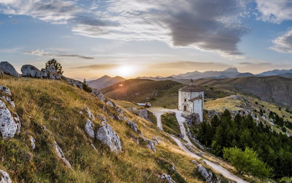 Chiesa di Santa Maria della Pieta from Rocca Calascio in Abruzzo, Italy in August during sunset - Kino Alyse/Getty Images