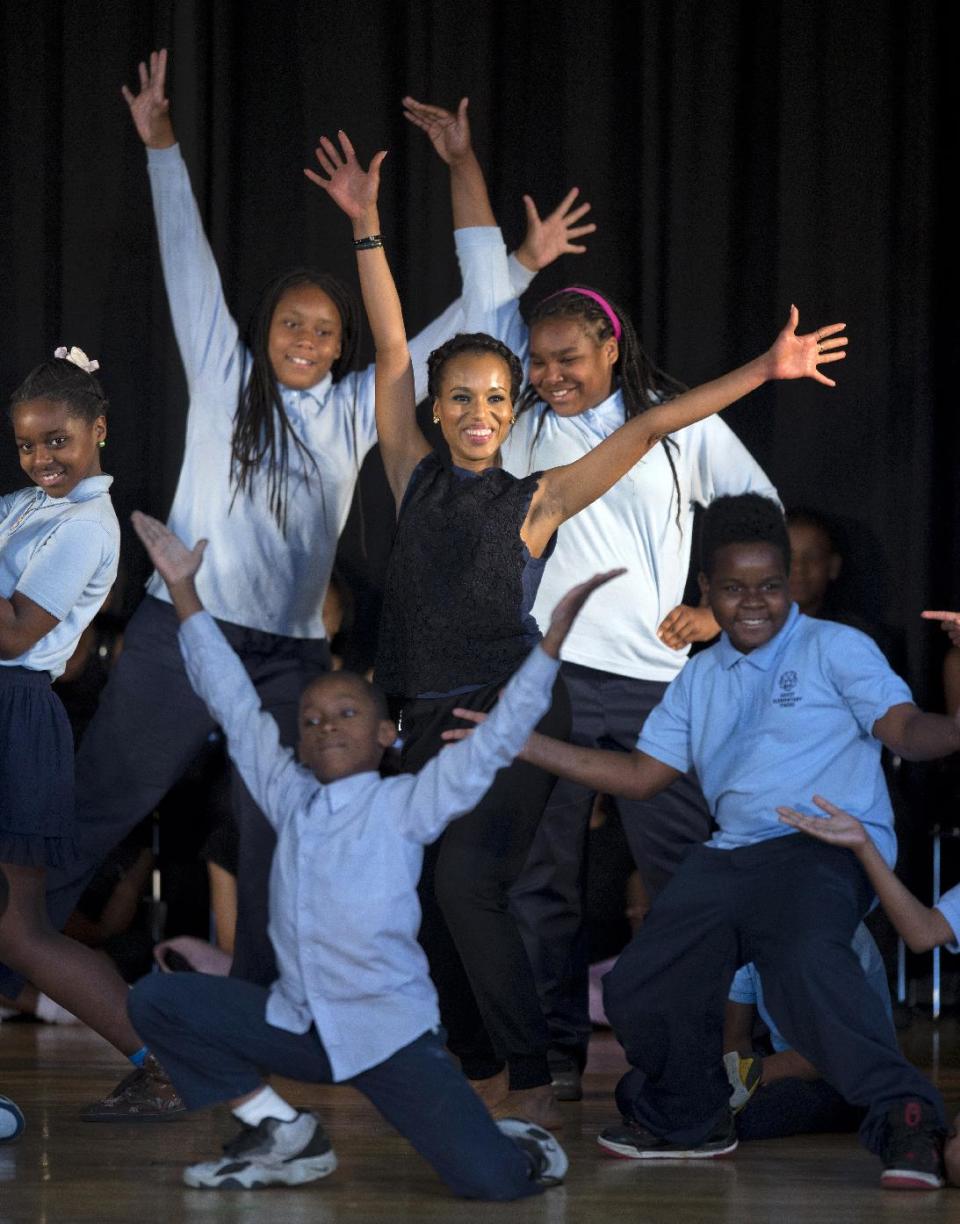 Actress Kerry Washington performs with students during a visit, along with first lady Michelle Obama, to Savoy Elementary School in Washington, Friday, May 24, 2013, in Washington. The Savoy School was one of eight schools selected last year for the Turnaround Arts Initiative at the President's Committee on the Arts and Humanities. Turnaround Arts Schools use the arts as a central part of their reform strategy to improve low performing schools (AP Photo/Evan Vucci)