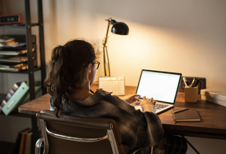 Teen girl doing homework on her laptop