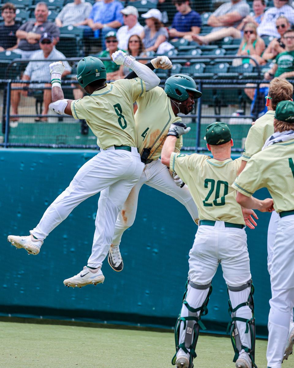 Jacksonville University's Tyrell Brewer (4) celebrates his home run with teammate Jaden Bastian (8) during Sunday's 9-6 victory over the University of North Florida, at JU's John Sessions Stadium.