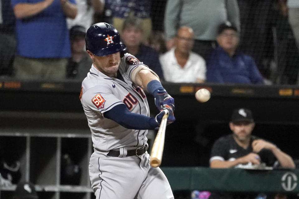 Houston Astros' Alex Bregman hits an RBI double off Chicago White Sox starting pitcher Dylan Cease during the third inning of a baseball game Tuesday, Aug. 16, 2022, in Chicago. (AP Photo/Charles Rex Arbogast)