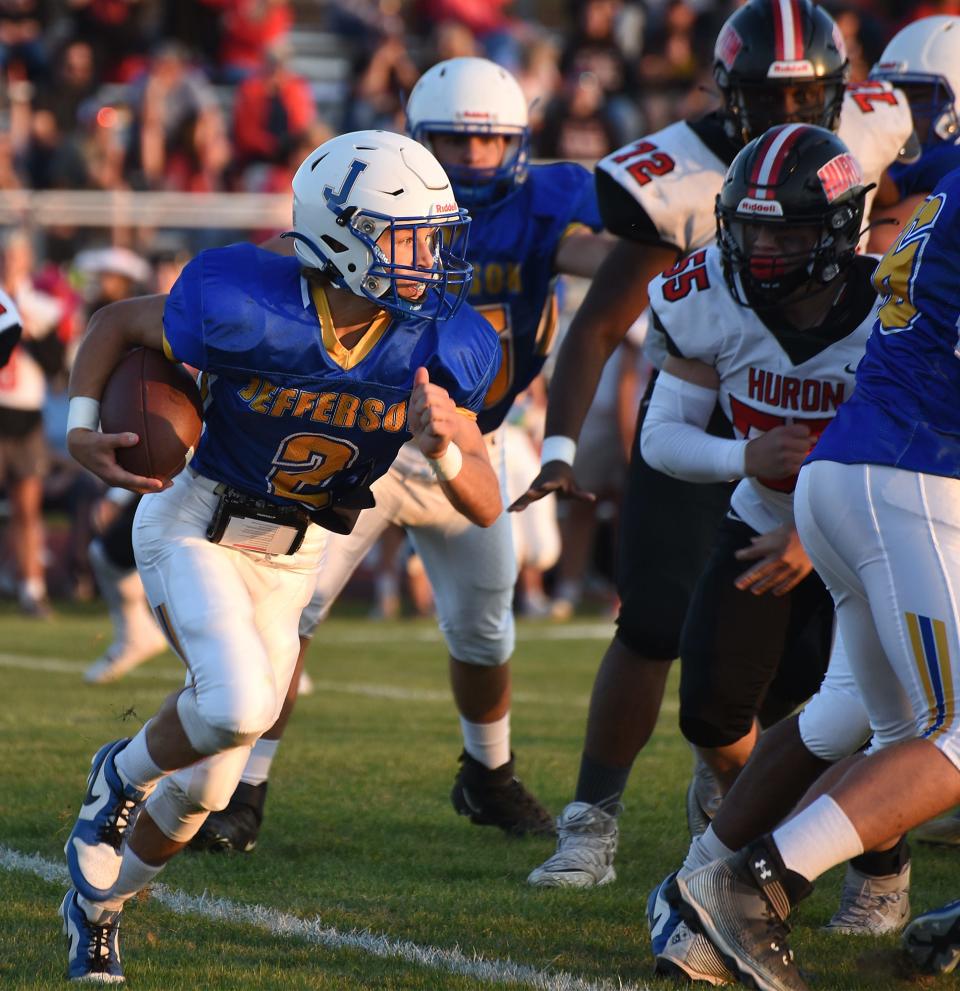 Quarterback Luke Beaudrie of Monroe Jefferson looks for an opening against New Boston Huron Friday, September 22, 2023.