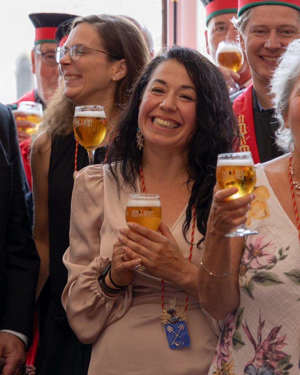 Lowlands Group COO Ileana Rivera smiles with a beer at her knighting ceremony in Belgium on Sept. 2, 2023.