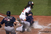 Boston Red Sox starting pitcher Nick Pivetta, right, tags out Baltimore Orioles' Freddy Galvis, center, trying to score on a wild pitch as catcher Christian Vazquez looks on during the third inning of a baseball game, Sunday, April 11, 2021, in Baltimore. (AP Photo/Julio Cortez)