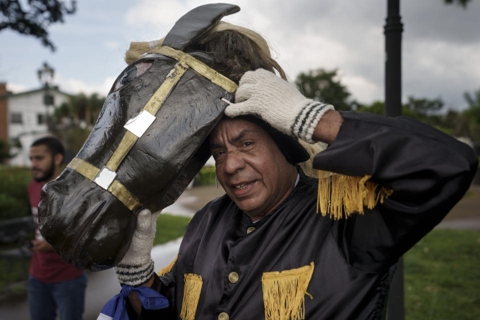 Nicaraguan asylum-seeker Carlos Eddy Monterrey wears the "Macho Raton" costume used to perform a traditional Nicaraguan dance as he meets with other exiled Nicaraguans in San Jose, Costa Rica, Friday, Aug. 26, 2022. Monterrey met with other Nicaraguans to film a short video that will be part of video showing Nicaraguans in exile worldwide. (AP Photo/Moises Castillo)