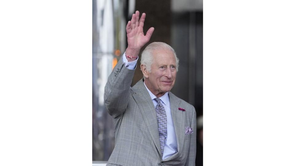 king charles waving in grey suit