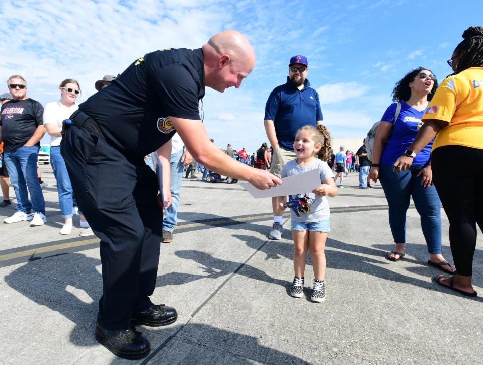 Blue Angels fans relax and peruse vendors and static plane displays ahead of the Blue Angels 2022 Homecoming Air Show on Saturday, Nov. 12, 2022.