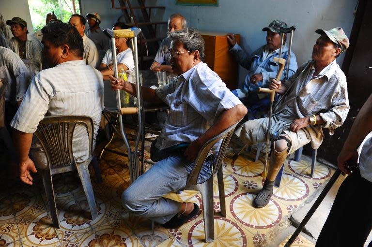 Disabled soldiers from the former US-backed southern Vietnam army wait to receive charity money at Lien Tri pagoda in Ho Chi Minh City on April 9, 2015