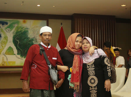 Siti Aisyah, who was previously a suspect in the murder case of North Korean leader's half brother Kim Jong Nam, poses with her parents after being released of her charges by Malaysian court, during a ceremony at Indonesian Foreign Ministry in Jakarta, March 11, 2019 in this photo taken by Antara Foto. Antara Foto/Reno Esnir/via REUTERS