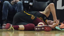 Cleveland Cavaliers' Lauri Markkanen grimaces in pain after an injury in the first half of an NBA basketball game against the Oklahoma City Thunder, Saturday, Jan. 22, 2022, in Cleveland. (AP Photo/Tony Dejak)