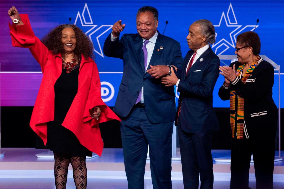 Reverend's Jesse Jackson, second from left, and Al Sharpton, second from right, gesture ahead of the a Democratic primary debate during the 2020 presidential campaign in Charleston, South Carolina, on Feb. 25, 2020.