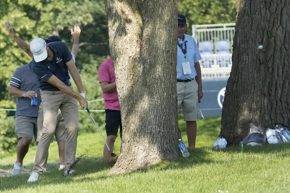 Chris Kirk hits his from rough between two trees to the fifth green during the second round of the BMW Championship golf tournament, Friday, Aug. 18, 2023, in Olympia Fields, Ill. (AP Photo/Charles Rex Arbogast)