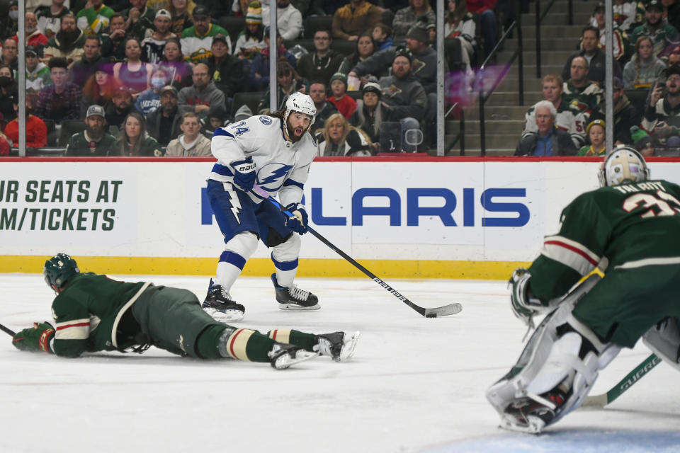 Tampa Bay Lightning left wing Pat Maroon looks for a shot on goal as Minnesota Wild defenseman Jordie Benn, left, and goalie Cam Talbot try to block his shot during the second period of an NHL hockey game Sunday, Nov. 28, 2021, in St. Paul, Minn. (AP Photo/Craig Lassig)