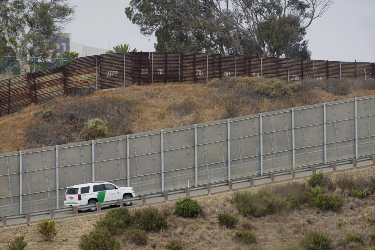 A Border Patrol car drives past the old border wall just east of where construction is set to begin on new fencing in San Ysidro, California. (Photo: SANDY HUFFAKER via Getty Images)