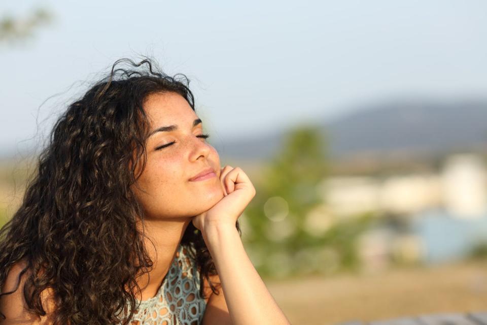 <span class="caption">Thich Nhat Hanh emphasized that mindfulness could be practiced anywhere.</span> <span class="attribution"><a class="link " href="https://www.shutterstock.com/image-photo/woman-relaxing-enjoying-sun-warmth-park-296425169" rel="nofollow noopener" target="_blank" data-ylk="slk:Antonio Guillem/Shutterstock.com;elm:context_link;itc:0;sec:content-canvas">Antonio Guillem/Shutterstock.com</a></span>