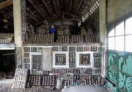 Stone collector Luigi Lineri, 79, walks through his stone collection found along Adige river, at his home workshop in Zevio, near Verona, Italy, June 10, 2016. REUTERS/Alessandro Bianchi