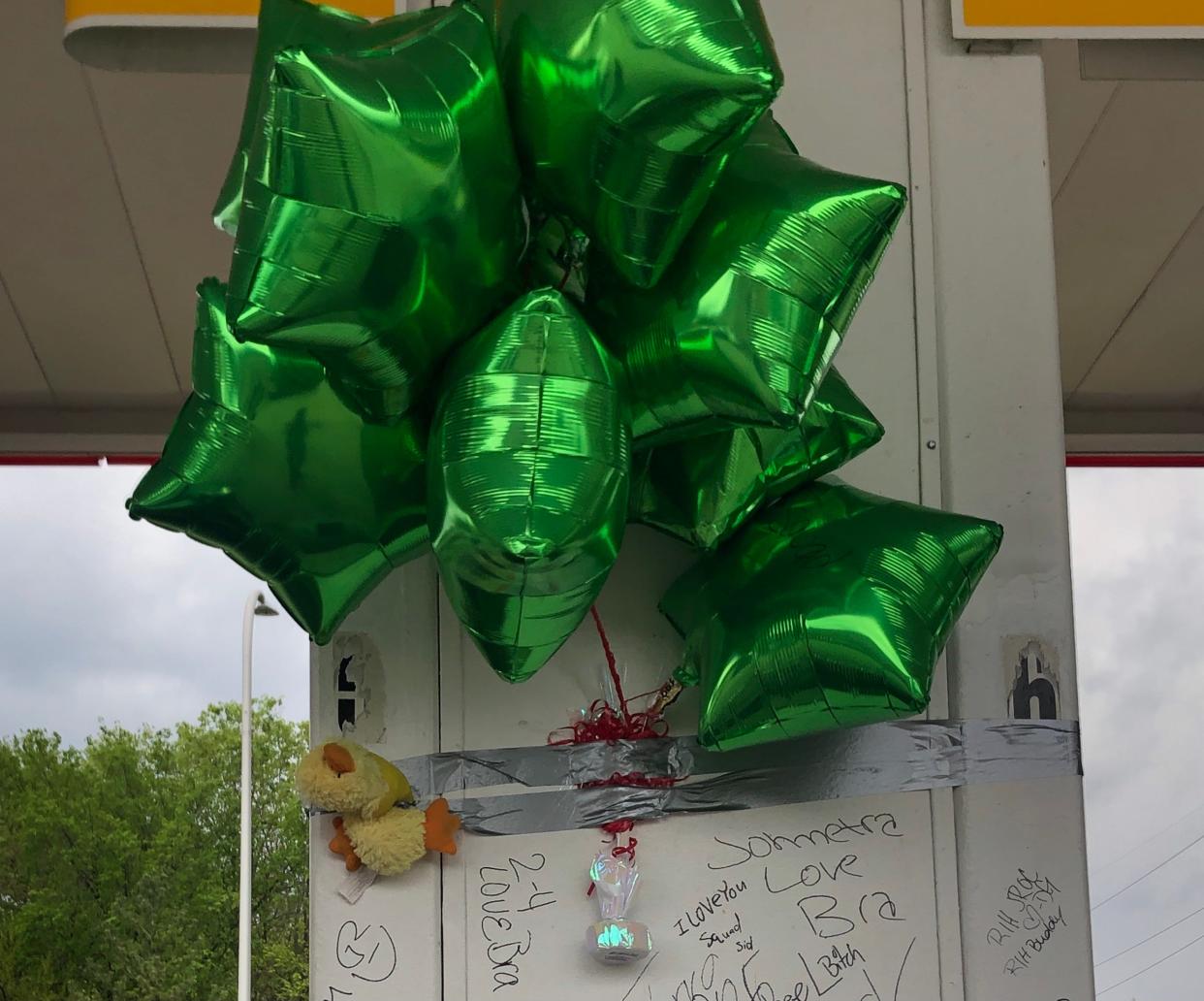 Balloons adorn a pillar at a South Peoria gas station where Joshua Perkins, 34, was shot and killed late Sunday May 9, 2021.