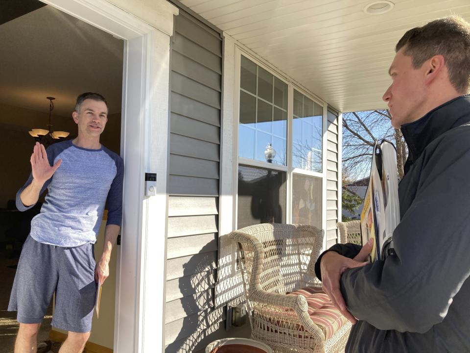 Matt Norris, a Democratic candidate for the Minnesota House, gets a pledge of support from voter Grant Cravens in Blaine, Minn., on Wednesday, Oct. 26, 2022. (AP Photo/Steve Karnowski)