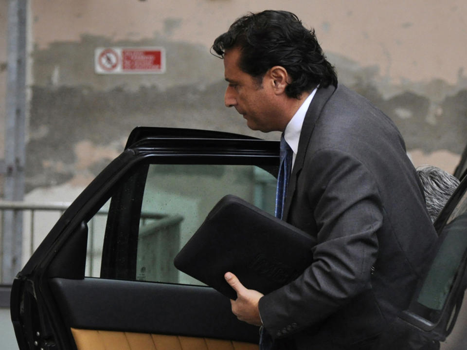 Francesco Schettino, the captain, arrives to attend the trial where he is accused of alleged manslaughter, abandoning ship and causing the shipwreck of the Costa Concordia near the Tuscan island of Giglio in January 2012, in Grosseto, Central Italy, Monday, Nov. 11, 2013. Stefano Iannelli, crewman-in-training, testified Monday that Schettino jumped, shortly before he himself did, onto the roof of a lifeboat. Iannelli said he didn't see any passengers still aboard. However, hours after Schettino abandoned ship, helicopters rescued people from the capsized vessel. (AP Photo/Giacomo Aprili)