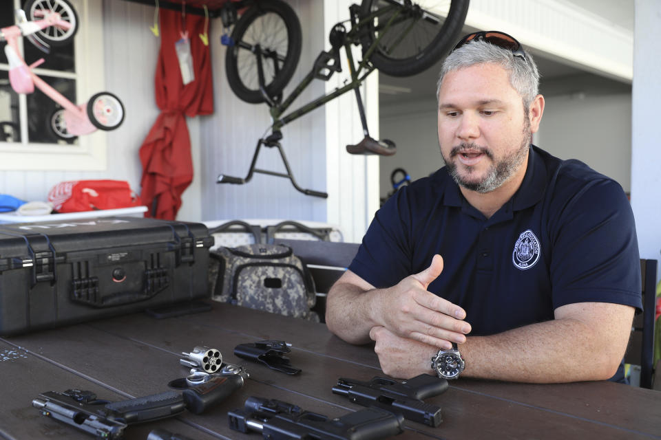 Kainoa Kaku, president of the Hawaii Rifle Association, discusses the recent U.S. Supreme Court Ruling while at his home, Thursday, June, 23, 2022, in Honolulu. (AP Photo/Marco Garcia)