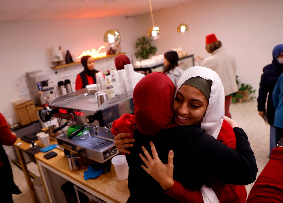 Reem Kounidry, right, is greeted with a hug as community members gather to watch the World Cup semifinal match between Morocco and France at La Recette patisserie in Durham, N.C. on Wednesday, Dec. 14, 2022.
