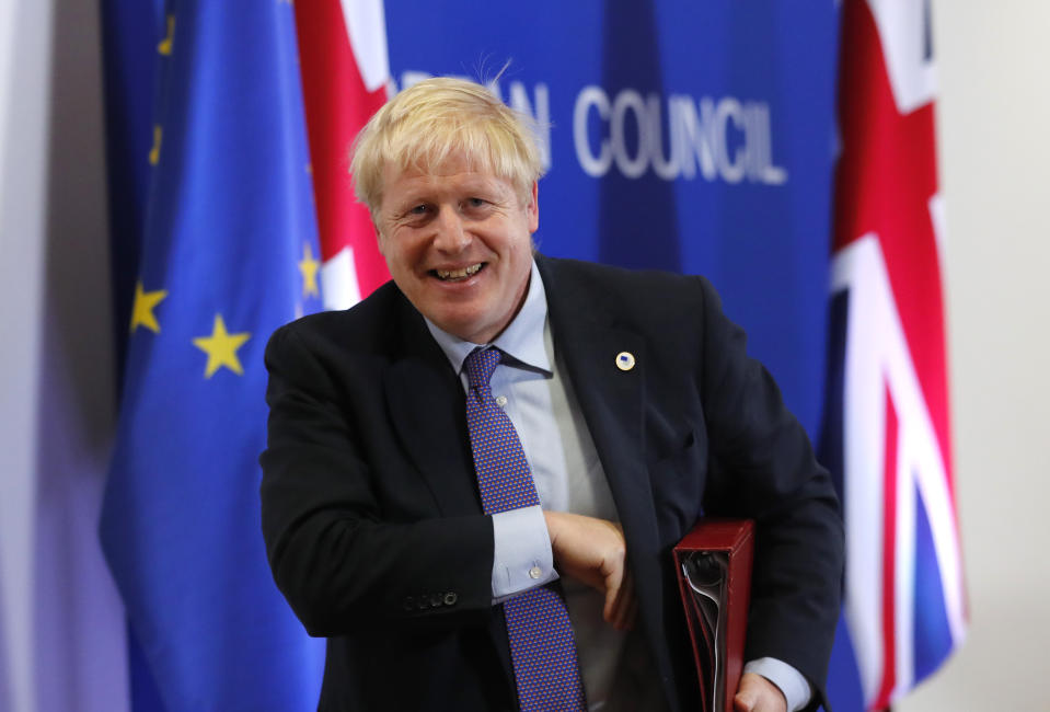 British Prime Minister Boris Johnson leaves the podium after addressing a media conference at an EU summit in Brussels, Thursday, Oct. 17, 2019. Britain and the European Union reached a new tentative Brexit deal on Thursday, hoping to finally escape the acrimony, divisions and frustration of their three-year divorce battle. (AP Photo/Frank Augstein)