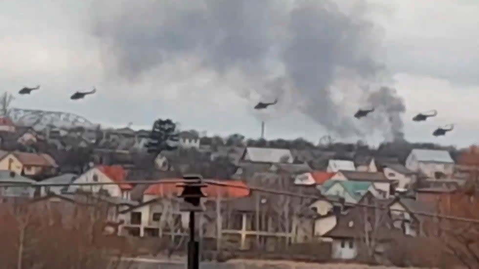 In a handout photo taken from video released by Ukrainian Police Department Press Service, apparently Russian helicopters, fly over the outskirts of Kyiv, Ukraine