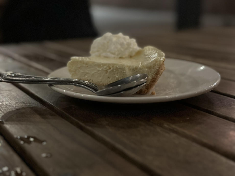 <p>A Portrait mode photo from the iPhone 14 Pro's main camera of a key lime pie on a table at night.</p>
