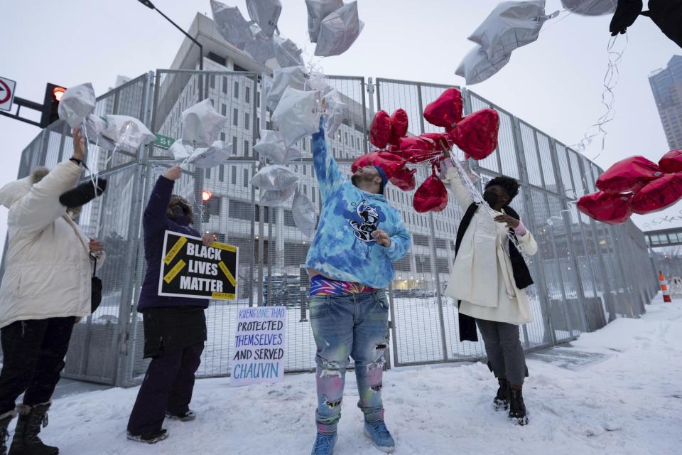 Damik Bryant, brother of Daunte Wright, center, and friends release balloons outside of the Warren E. Burger Federal Building after former Minneapolis police officers J. Alexander Kueng, Tou Thao, and Thomas Lane were found guilty of depriving George Floyd of his right to medical care on Thursday, Feb. 24, 2022, in St. Paul, Minn. (AP Photo/Christian Monterrosa)