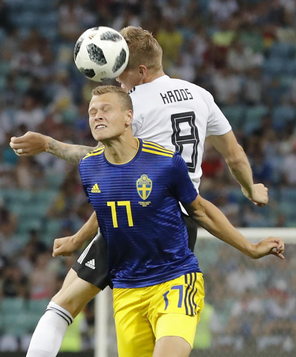 <p>Sweden’s John Guidetti, left, and Germany’s Toni Kroos jump for the ball during the group F match between Germany and Sweden at the 2018 soccer World Cup. </p>
