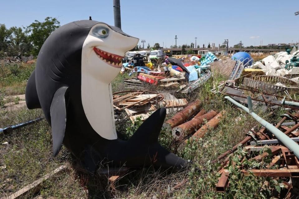 a large plastic shark among other color debris