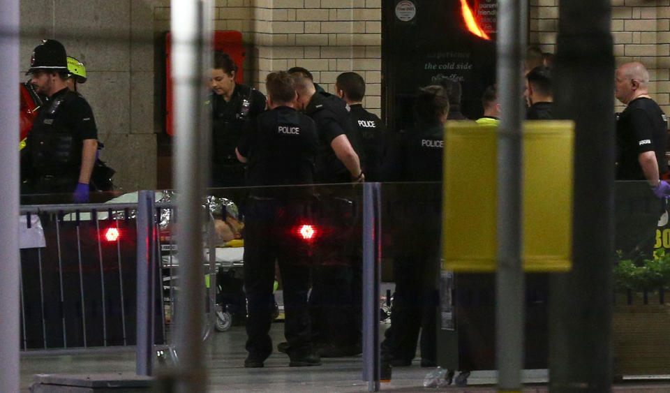 <p>A person is wheeled away on a stretcher at Victoria Railway Station close to the Manchester Arena on May 23, 2017 in Manchester, England. (Dave Thompson/Getty Images) </p>