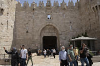 Israeli police use the Damascus Gate to watch Muslim worshippers leave the Old City of Jerusalem after Friday prayers during the Muslim holy month of Ramadan, on Friday, April 23, 2021. Israeli police say 44 people were arrested and 20 officers were wounded in a night of chaos in Jerusalem, where security forces separately clashed with Palestinians angry about Ramadan restrictions and Jewish extremists who held an anti-Arab march nearby. (AP Photo/Maya Alleruzzo)