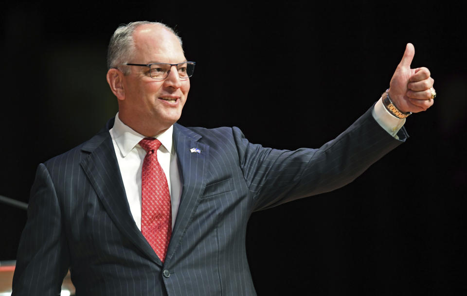 Gov. John Bel Edwards acknowledges his supporters as he comes out on stage for a debate with Eddie Rispone and Republican Rep. Ralph Abraham as they participate in the first televised gubernatorial debate Thursday Sept. 19, 2019, in Baton Rouge, La. (Bill Feig/The Advocate via AP, Pool)