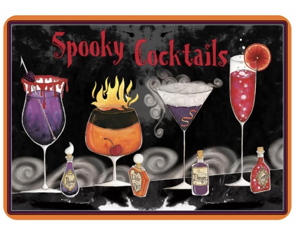 The mat says "Spooky Cocktails" has four creepy cocktail drinks and four small bottles next to them