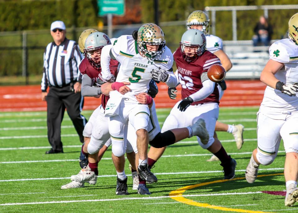 Bishop Feehan's Matt Saunders has the ball stripped loose by Bishop Stang's Colin McCarthy. Stang's Aiden Roderick has the loose ball in his sights.