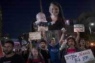 Families and their supporters carry large photos depicting women held hostage by Hamas in the Gaza Strip in a march to call on Israeli Prime Minister Benjamin Netanyahu's government to make a deal to free their loved ones, in Tel Aviv, Israel, Wednesday, May 8, 2024. At center is Shiri Bibas with her child, Kfir; at left is Noa Argamani. (AP Photo/Maya Alleruzzo)