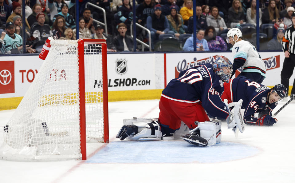 Seattle Kraken forward Jordan Eberle, center, scores past Columbus Blue Jackets goalie Daniil Tarasov, left, and defenseman Erik Gudbranson during the first period NHL hockey game in Columbus, Ohio, Saturday, Jan. 13, 2024. (AP Photo/Paul Vernon)