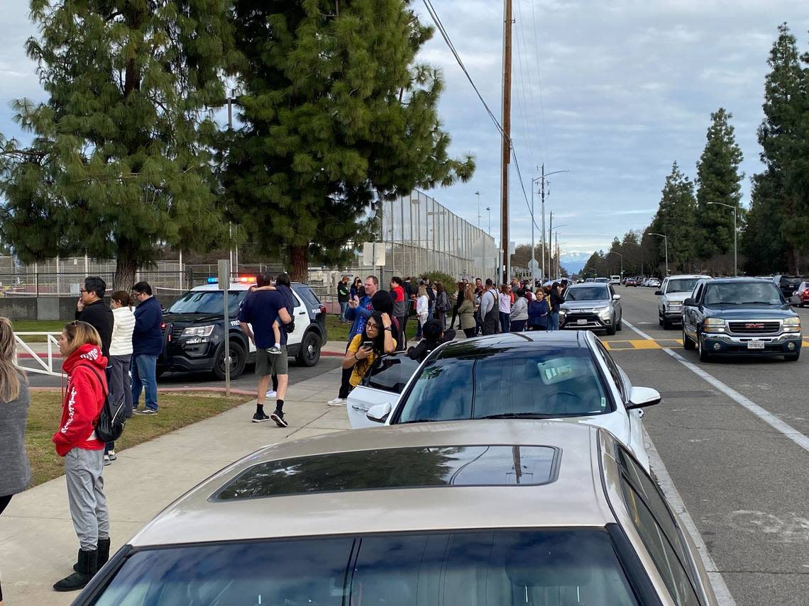Relatives of students wait outside Clovis West High School in Fresno, California, on Friday, Feb. 3, 2023, after the campus was locked down due to the threat of a shooting.