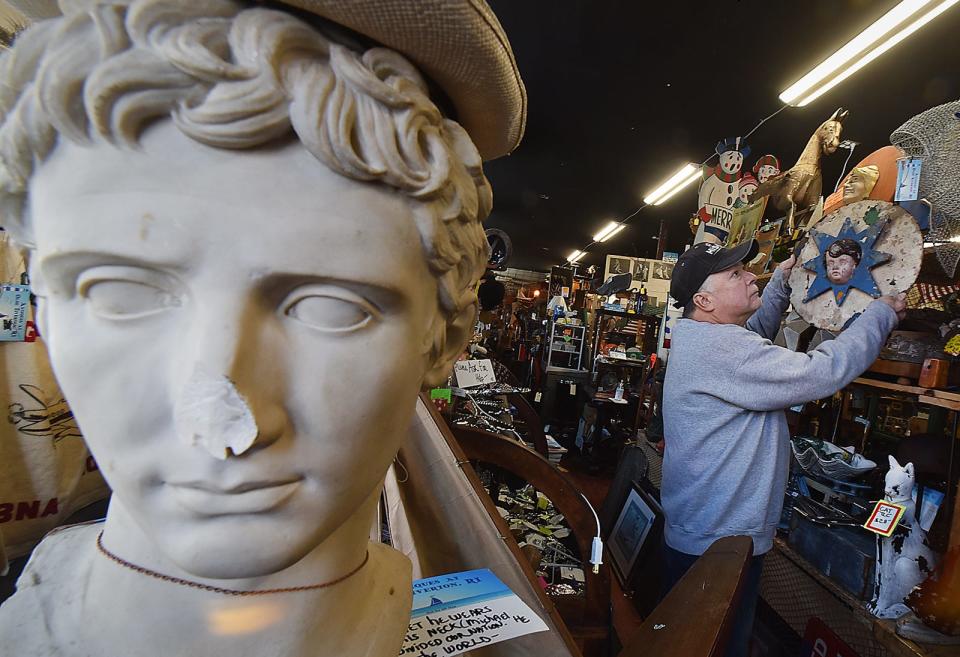 Owner of Antiques at Olde Tiverton, RI Peter Lacasse hangs part of an old carousel in his shop on Main Road in Tiverton Monday Jan. 22 2024.