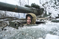 A Ukrainian soldier looks out of a self-propelled artillery vehicle on the frontline, Donetsk region, Ukraine, Saturday, Feb. 18, 2023. (AP Photo/Libkos)