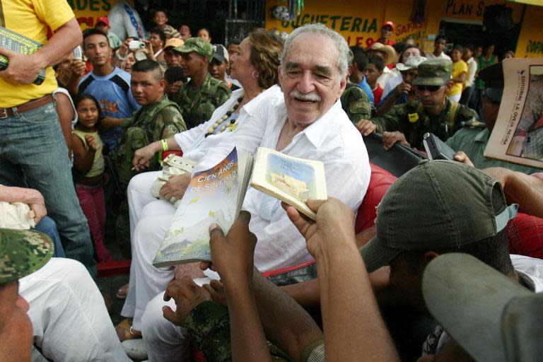 Nobel Prize for Literature winner in 1982 Gabriel Garcia Marquez, sitting alongside his wife Mercedes Barcha, is asked by admirers to dedicate books before boarding the train to his hometown Aracataca on May 30, 2007 in Santa Marta, Colombia