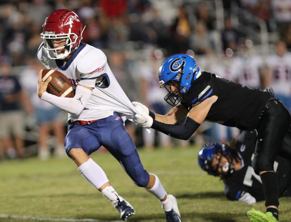 East Gaston's Trent Sherrill tries to elude the grasp of a Cherryville tackler during their game on Sept. 22, 2023.