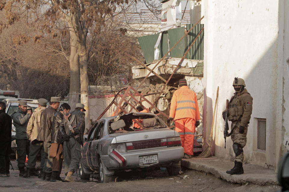 Afghan security forces investigate the aftermath of Friday's suicide attack and shooting in Kabul, Afghanistan, Saturday, Jan. 18, 2014. A suicide bomber blew himself up outside a Kabul restaurant filled with foreigners and affluent Afghans, while two gunmen snuck in through the back door and opened fire Friday in a brazen dinnertime attack that killed 16 people, officials said. (AP Photo/Rahmat Gul)