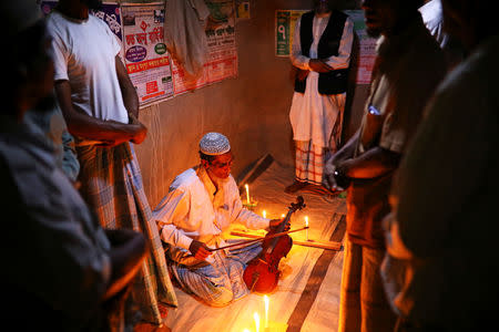 Amir Ali, a Rohingya violinist who was a member of a wedding band of the northern Rakhine State of Myanmar, attends a prayer event to play the violin at the Kutupalong refugee camp in Cox's Bazar, Bangladesh, March 7, 2019. REUTERS/Mohammad Ponir Hossain