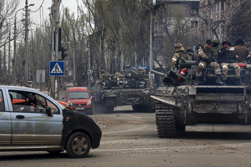 FILE - Russian tanks roll along a street in an area controlled by Russian-backed separatist forces in Mariupol, Ukraine, April 23, 2022. (AP Photo/Alexei Alexandrov, File)