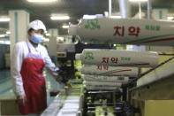 An employees of Pyongyang Dental Hygiene Products Factory produces toothpaste for citizens as the state increased measures to stop the spread of illness in Pyongyang, North Korea Monday, May 16, 2022. (AP Photo/Cha Song Ho)