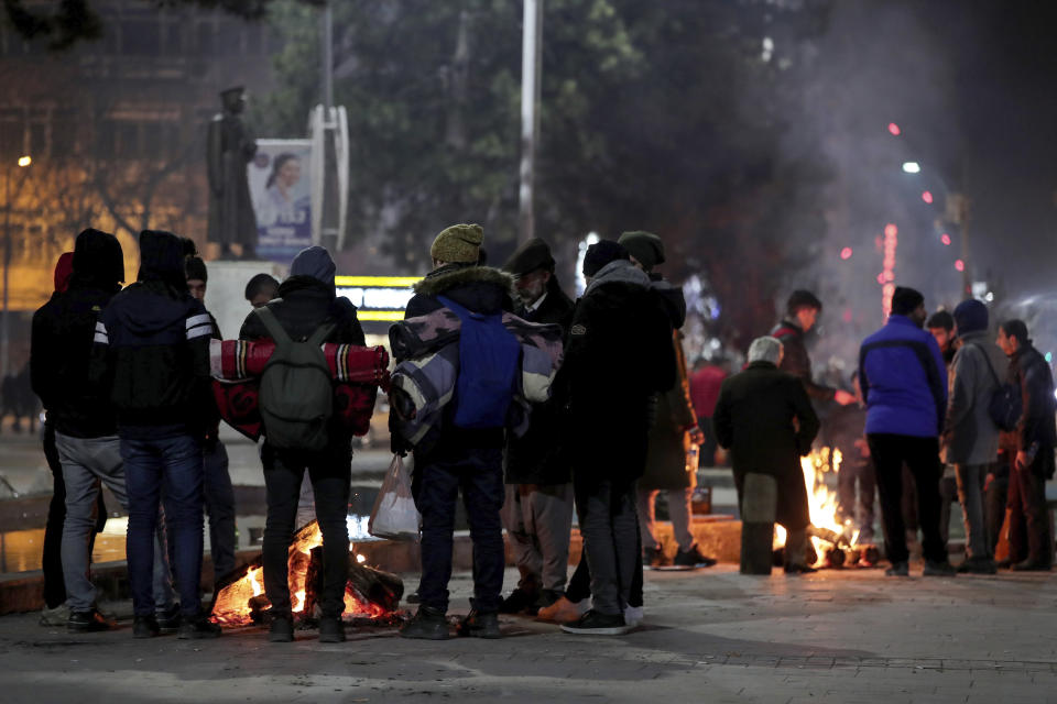 People gather around fires to spend the night following Friday's earthquake that destroyed their houses, in Elazig, eastern Turkey, late Saturday, Jan. 25, 2020. More than 24 hours after a powerful earthquake hit eastern Turkey rescuers continued to pull survivors from under collapsed buildings Sunday. (Ugur Can/DHA via AP)